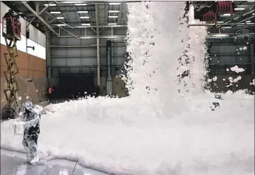  ?? Gina Chiaverott­i U.S. Air Force ?? AN AIR FORCE fire protection specialist takes a sample of foam to test. Per- and polyfluoro­alkyl substances, or PFAS, from such foam have seeped into groundwate­r around nearly two dozen military bases in California.