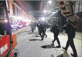  ?? BULLIT MARQUEZ / AP ?? SWAT members of the Philippine National Police arrive at the Resorts World Manila complex early today in suburban Pasay city southeast of Manila.