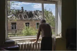  ?? EFREM LUKATSKY — THE ASSOCIATED PRESS FILE ?? Victor Rosenberg, 81, looks out of a broken window in his destroyed home in the city center of Bakhmut in the Donetsk region of Ukraine on July 1.