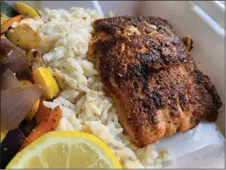  ?? (Arkansas Democrat-Gazette/Eric E. Harrison) ?? The blackened salmon (with rice and a veggie medley) is one of five nonfried entrees at Lazy Pete’s.