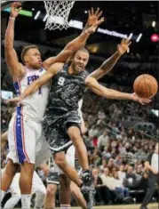  ?? DARREN ABATE — THE ASSOCIATED PRESS ?? The San Antonio Spurs’ Tony Parker (9) passes the ball as Philadelph­ia 76ers’ Justin Anderson defends during the first half of an NBA game Friday in San Antonio.