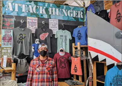  ?? COURTESY MONICA DRAKE ?? Mike Ash of St. Clair Shores sells printed tees, hoodies, bags and socks at Rust Belt Market in Ferndale every weekend.