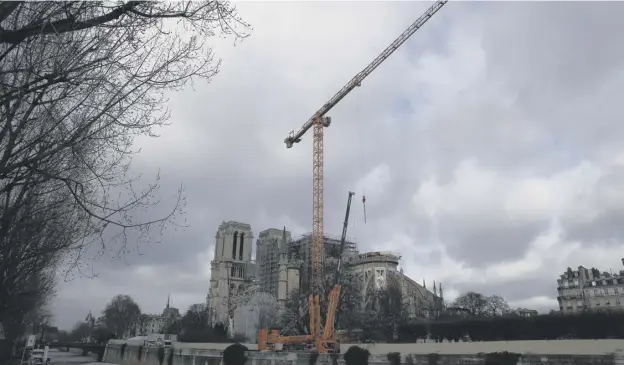  ?? PICTURE: AP ?? 0 Notre Dame remains covered in scaffoldin­g with a giant crane standing over it with restoratio­n work unlikely to begin until 2021
