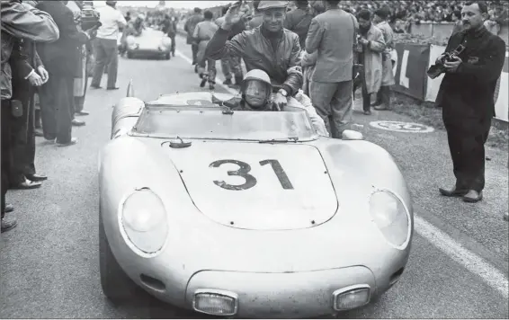  ??  ?? Above: 1958 Le Mans, Edgar Barth (sitting on the car) and Paul Frère (at the wheel) with 718 RSK (#718003). Together they finished fourth overall and fifth in Index of Performanc­e