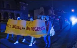  ?? Emily Matthews/Post-Gazette ?? Protesters march down Lincoln Avenue in Larimer to demand justice for Jim Rogers, who died after being tased by a Pittsburgh Police officer, on Nov. 30.