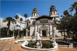  ?? JOE JOHNSTON — THE TRIBUNE OF SAN LUIS OBISPO VIA AP, FILE ?? Smoke from a wildfire billows from a ridge line behind famed facade of Hearst Castle in San Simeon.