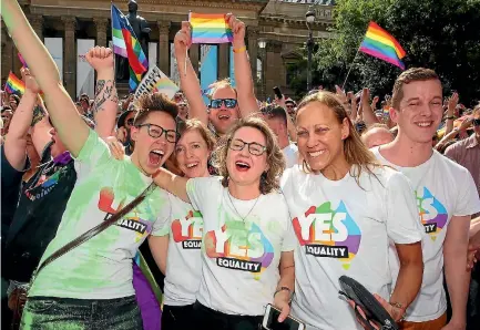  ?? PHOTO: GETTY IMAGES ?? Supporters of same-sex marriage celebrate outside the State Library in Melbourne after the result of the postal survey - a 61.6 per cent ‘‘yes’’ vote - is announced. Australia’s federal parliament is set to debate a law change.