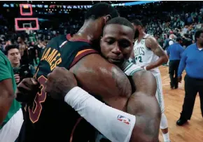  ?? ASSOCIATED PRESS ?? Cavaliers forward LeBron James embraces Celtics guard Terry Rozier after Cleveland beat Boston, 87-79, in the decisive Game 7 of the Eastern Conference finals on Sunday night.