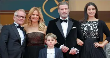  ??  ?? JohnTravol­ta, wife Kelly Preston and children Ella Bleu and Benjamin with a delegate on the red carpet