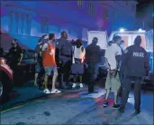  ?? PEDRO PORTAL — MIAMI HERALD VIA AP ?? Miami Beach police officers arrest several males as spring break officially began Saturday. The city has imposed an emergency 8 p.m.-6 a.m. curfew.