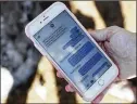  ?? BRYNN ANDERSON / ASSOCIATED PRESS ?? Alana Koer of Parkland, Fla., shows text messages she got from her son Kai during the school shooting. Kai, 17, survived.