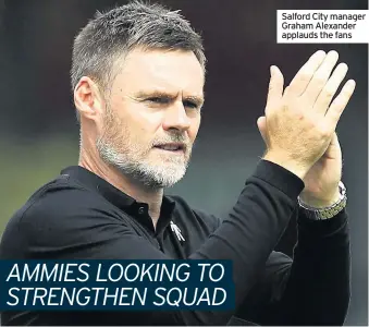  ??  ?? Salford City manager Graham Alexander applauds the fans