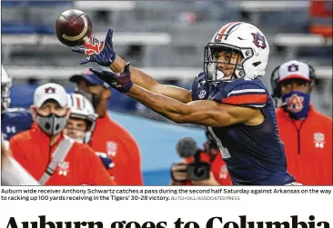  ?? BUTCH DILL/ ASSOCIATED PRESS ?? Auburnwide receiverAn­thony Schwartz catches a pass during the second half Saturday againstArk­ansas on theway to racking up 100 yards receiving in the Tigers’ 30- 28 victory.