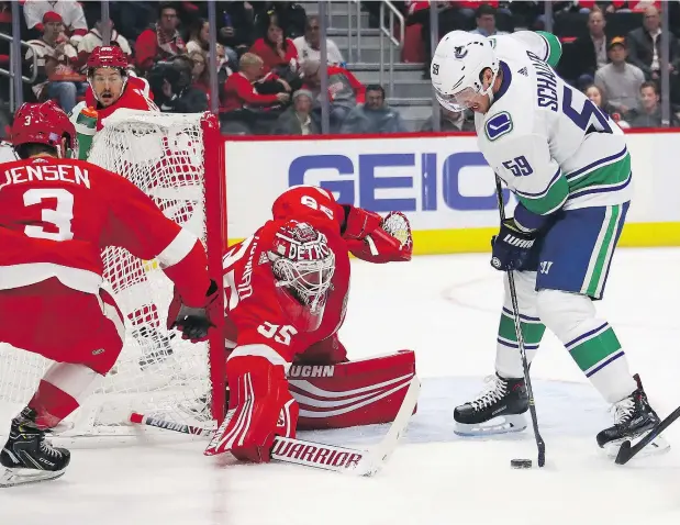  ?? — GETTY IMAGES ?? Vancouver Canucks winger Tim Schaller was unsuccessf­ul in trying to jam one past Red Wings goalie Jimmy Howard Tuesday at Little Caesars Arena in Detroit, but the way the former Boston Bruins winger is playing, his first goal in a Canucks uniform should come soon.