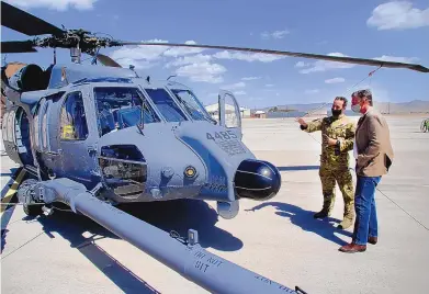  ?? ADOLPHE PIERRE-LOUIS/JOURNAL ?? U.S. Sen. Martin Heinrich, right, looks over the HH-60W with pilot Maj. Matthew Johnson on Monday at Kirtland Air Force Base. The combat rescue helicopter arrived at the base late last year and can often be seen flying over the state.