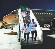  ?? AP ?? Saudi Arabia’s team leave the plane after arriving at the Rostov-on-Don airport on Monday.