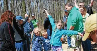  ?? LISA MITCHELL - DIGITAL FIRST MEDIA ?? Children and their parents celebrate Earth Day while reading “Chippy Chipmunk Feels Empathy” during StoryWalk® -Reading on the Trail, lead by local author Kathy Miller, Hawk Mountain Sanctuary in Kempton on April 22. Children soar like eagles to the...