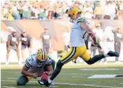 ?? DYLAN BUELL/GETTY ?? After missing three straight field goals, the Packers’ Mason Crosby kicks the game-winner Sunday.