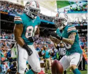  ?? THE PALM BEACH POST ?? Leonte Carroo (88) and Kenny Stills celebrate Carroo’s touchdown catch — one of only three receptions in his rookie season — against the 49ers.