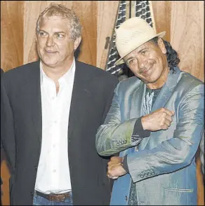  ?? Las Vegas Review-Journal file ?? Concerts West chief John Meglen, left, and Carlos Santana at a 2009 ribbon-cutting ceremony. Meglen is girding for the return of live shows.