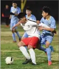  ?? RECORDER PHOTO BY CHIEKO HARA ?? Lindsay High School’s Moises Betancourt, left, keeps the ball as Monache High School’s Cristian Cega marks on Tuesday, Nov. 20, 2018 during the second half of a game at Monache High School.