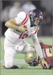  ?? PHOTO BY STREETER LECKA/GETTY IMAGES ?? Ole Miss’ Chad Kelly was up and down Monday night against Florida State and Matthew Thomas. Kelly went 21 of 39 for 321 yards, four touchdowns and three intercepti­ons.