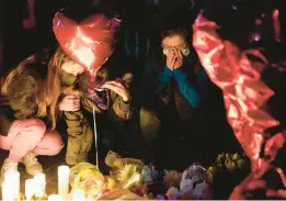  ?? ASHLEY LANDIS/AP ?? Mourners attend a vigil last week at a makeshift memorial honoring the victims of a Jan. 21 mass shooting at the Star Ballroom Dance Studio in Monterey Park, Calif.