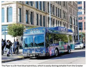  ?? CORNELIUS FROLIK/STAFF ?? The Flyer is a 30-foot blue hybrid bus, which is easily distinguis­hable from the Greater Dayton Regional Transit Authority’s other fleets of buses, which are green and gray. The Flyer shuttles will have 23 seats and additional standing room.