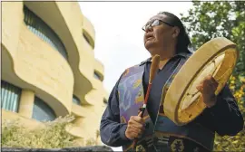  ?? SUSAN WALSH — THE ASSOCIATED PRESS ?? Dennis Zotigh stands outside the National Museum of the American Indian in Washington on Friday. Many tribes have their own anthems known as flag songs that focus on veterans.