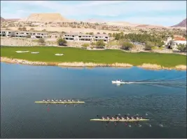  ?? MICHAEL QUINE/ LAS VEGAS REVIEW-JOURNAL ?? The University of Washington women’s rowing team maintains their lead against University of Southern California on Saturday, the first day of the competitio­n in the Collegiate Invitation­al Rowing Regatta at Lake Las Vegas.