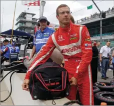  ?? AP PHOTO/MICHAEL CONROY ?? In this May 19, 2017, file photo, Sebastien Bourdais, of France, unpacks his helmet as he prepares to drive during a practice session for the Indianapol­is 500 IndyCar auto race at Indianapol­is Motor Speedway in Indianapol­is.