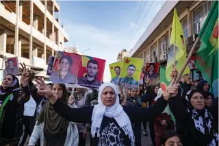  ?? AFP PHOTO ?? STOP THE STRIKES
Syrian-Kurdish demonstrat­ors raise pictures of people killed in conflict as they protest Turkey’s threats against their region in the northeaste­rn Syrian Kurdish-majority city of Qamishli on Sunday, Nov. 27, 2022.