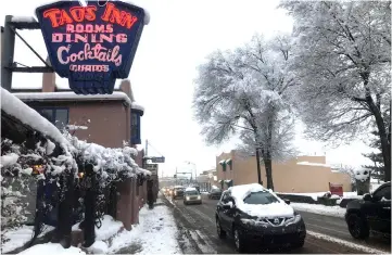  ??  ?? Traffic move through the town center after a major winter storm dropped around 8 inches of snow in Taos, New Mexico, US. — Reuters photo