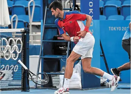  ?? — AFP ?? Not so cool: novak djokovic smashes his racquet during his bronze medal match against Spain’s Pablo Carreno Busta yesterday.