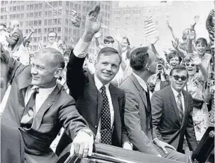  ?? CHICAGO TRIBUNE ?? Apollo 11 Astronauts Edwin “Buzz” Aldrin, from left, Neil Armstrong and Michael Collins acknowledg­e the cheers of a Chicago crowd on Aug. 13, 1969.