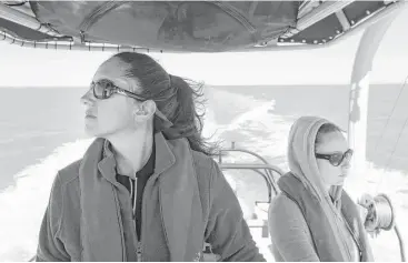  ?? Melissa Phillip / Houston Chronicle ?? Kristi Fazioli, left, and Sherah Loe, both with the Environmen­tal Institute of Houston at the University of Houston-Clear Lake, spend hours searching for dolphins in Galveston Bay in February.