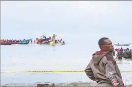  ?? AYO TV ?? RESCUERS HELP passengers from a plane that crashed Sunday into Lake Victoria in Tanzania. The f light encountere­d bad weather, authoritie­s say.