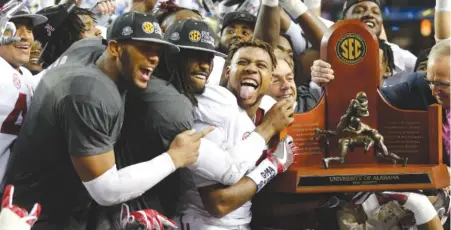  ?? | JOHN BAZEMORE/ AP ?? Alabama players celebrate after humbling Florida in the Southeaste­rn Conference championsh­ip game Saturday in Atlanta.