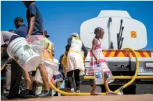  ?? AP-Yonhap ?? Residents queue for water in the township of Soweto, South Africa, March 16.