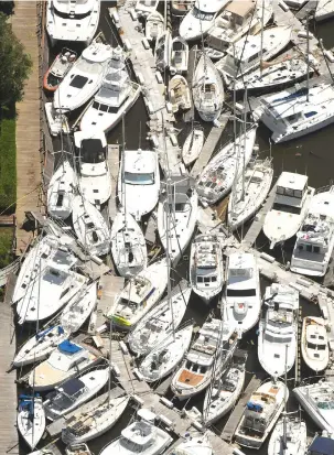  ?? KEN BLEVINS/WILMINGTON STAR-NEWS VIA AP ?? In this aerial photo, boats are stacked on top of each other in the Southport Marina on Tuesday in Southport North Carolina after Tropical Storm Isaias came ashore over night.
