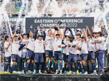  ?? Chris Szagola/Associated Press ?? The Philadelph­ia Union’s Kai Wagner, center, lifts the trophy as his team celebrates a win against New York City FC last October.