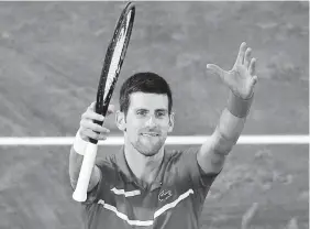  ?? Christophe Ena, The Associated Press ?? Novak Djokovic celebrates winning his semifinal against Stefanos Tsitsipas, 6- 3, 6- 2, 5- 7, 4- 6, 6- 1, at the French Open on Friday.