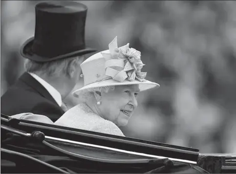  ?? The Associated Press ?? DAY AT THE RACES: Britain’s Queen Elizabeth II arrives by carriage for day four of the Royal Ascot meeting at England’s Ascot Racecourse on Friday.