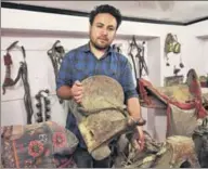  ??  ?? Munshi Aziz Bhat’s great grandson Muzammil Hussain holds an antique horse saddle, Kargil, Jammu and Kashmir