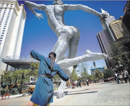  ?? PHOTOS BY JEFF SCHEID/LAS VEGAS REVIEW-JOURNAL FOLLOW @JLSCHEID ?? Mora Rojas of Guatemala strikes a pose similar to the “Bliss Dance” statue at The Park on April 5.