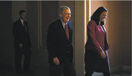  ?? Alex Wong / Getty Images ?? Senate Majority Leader Mitch McConnell, R-Ky., shown with an aide, launched the freewheeli­ng debate on the Senate floor.