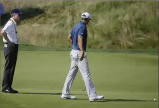  ?? ASSOCIATED PRESS FILE PHOTO ?? In this June 19 photo, Dustin Johnson, right, talks to a rules official on the fifth green during the final round of the U.S. Open in Oakmont, Pa. Johnson was penalized when his ball moved slightly before a putt.