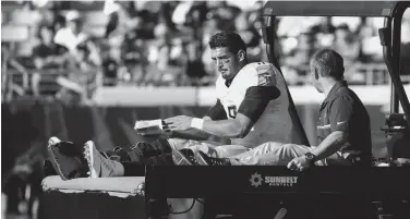  ?? LOGAN BOWLES-USA TODAY SPORTS ?? Tennessee Titans quarterbac­k Marcus Mariota (8) is carted off in the second half after sustaining an injury against the Jacksonvil­le Jaguars at EverBank Field. The Jacksonvil­le Jaguars won 38-17.