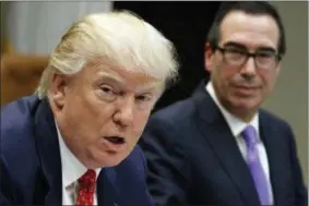  ?? EVAN VUCCI — THE ASSOCIATED PRESS FILE ?? In this file photo photo, Treasury Secretary Steven Mnuchin listens at right as President Donald Trump speaks during a meeting on the Federal budget in the Roosevelt Room of the White House in Washington. Trump wants to tackle tax reform, but the loss...