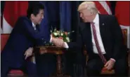  ?? EVAN VUCCI — THE ASSOCIATED PRESS ?? President Donald Trump shakes hands with Japanese Prime Minister Shinzo Abe during a meeting at the G7 Summit, on Friday in Taormina, Italy.